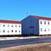 Contractors moving four World War II-era barracks buildings at Fort McCoy