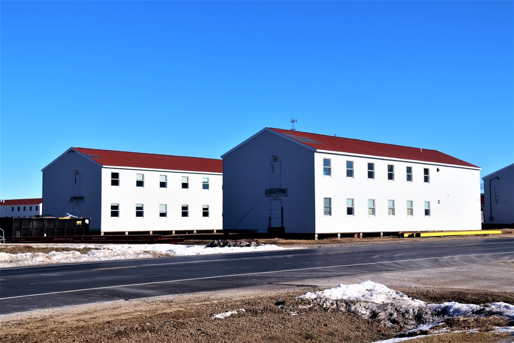 Contractors moving four World War II-era barracks buildings at Fort McCoy