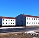 Contractors moving four World War II-era barracks buildings at Fort McCoy