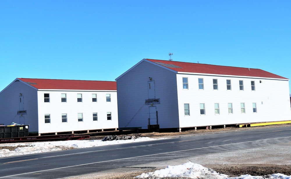 Contractors moving four World War II-era barracks buildings at Fort McCoy