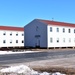 Contractors moving four World War II-era barracks buildings at Fort McCoy