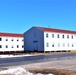 Contractors moving four World War II-era barracks buildings at Fort McCoy