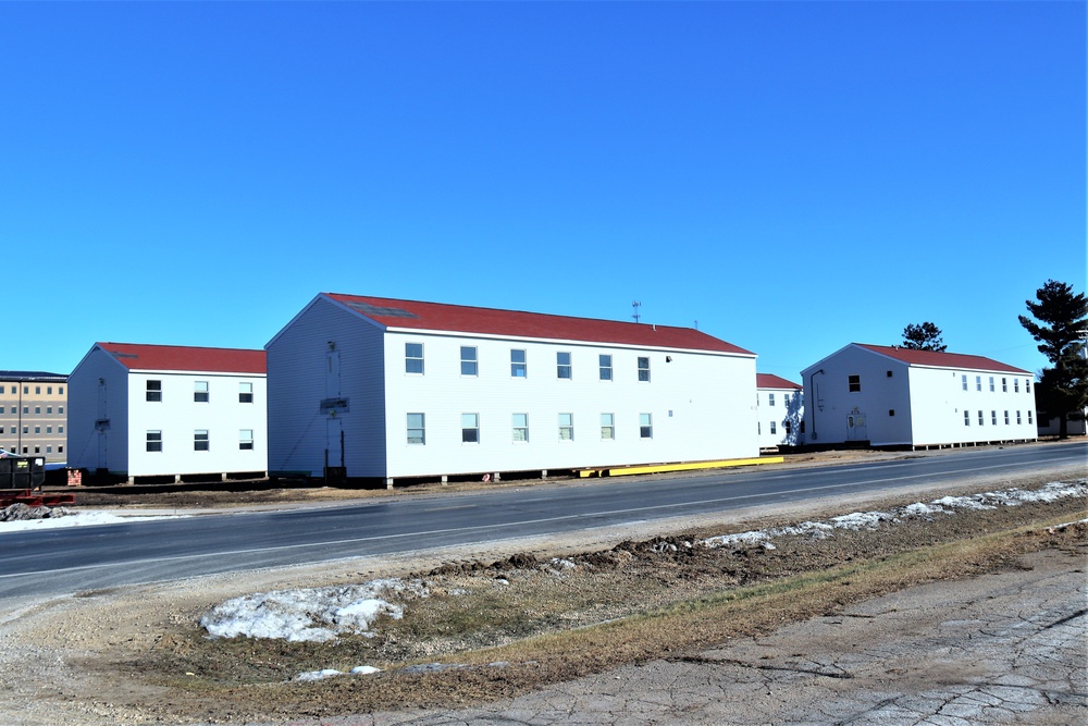 Contractors moving four World War II-era barracks buildings at Fort McCoy