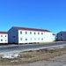 Contractors moving four World War II-era barracks buildings at Fort McCoy