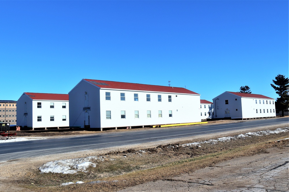 Contractors moving four World War II-era barracks buildings at Fort McCoy