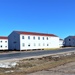 Contractors moving four World War II-era barracks buildings at Fort McCoy