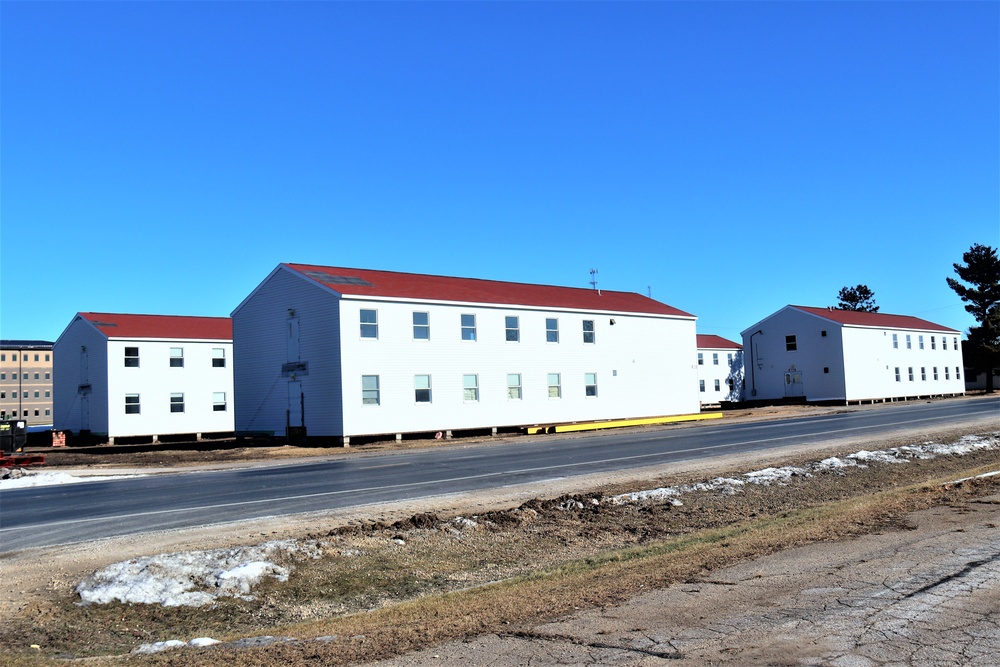 Contractors moving four World War II-era barracks buildings at Fort McCoy