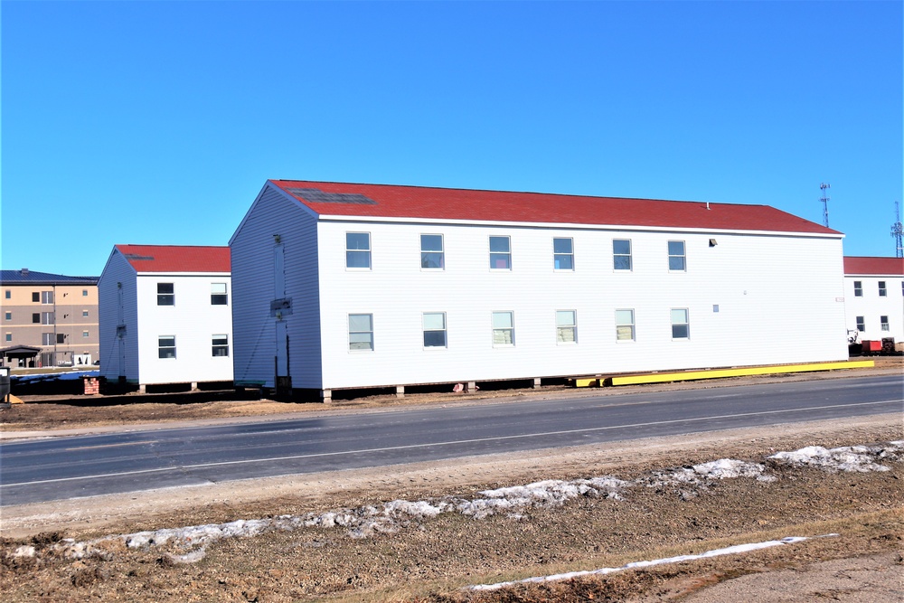 Contractors moving four World War II-era barracks buildings at Fort McCoy