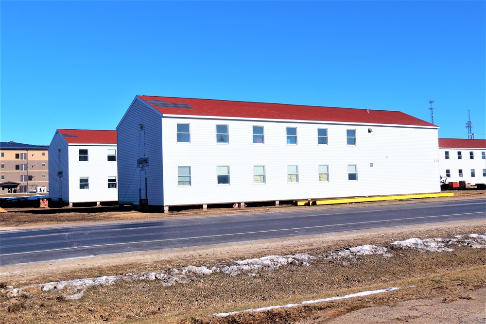 Contractors moving four World War II-era barracks buildings at Fort McCoy