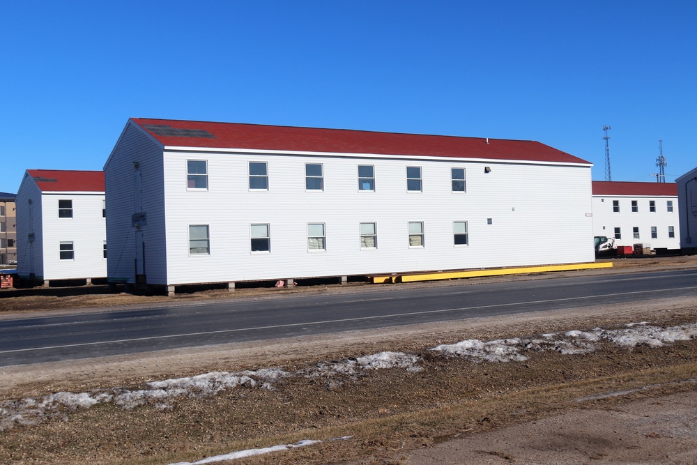 Contractors moving four World War II-era barracks buildings at Fort McCoy