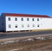 Contractors moving four World War II-era barracks buildings at Fort McCoy