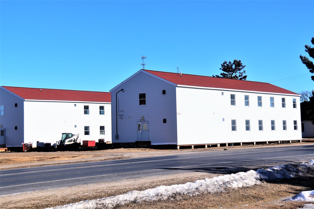 Contractors moving four World War II-era barracks buildings at Fort McCoy