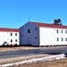 Contractors moving four World War II-era barracks buildings at Fort McCoy