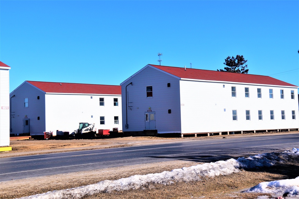 Contractors moving four World War II-era barracks buildings at Fort McCoy