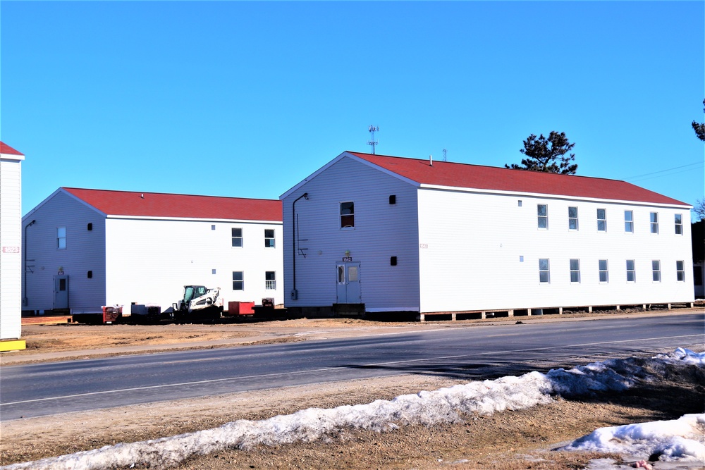 Contractors moving four World War II-era barracks buildings at Fort McCoy