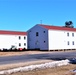 Contractors moving four World War II-era barracks buildings at Fort McCoy