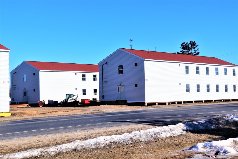 Contractors moving four World War II-era barracks buildings at Fort McCoy