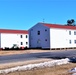 Contractors moving four World War II-era barracks buildings at Fort McCoy