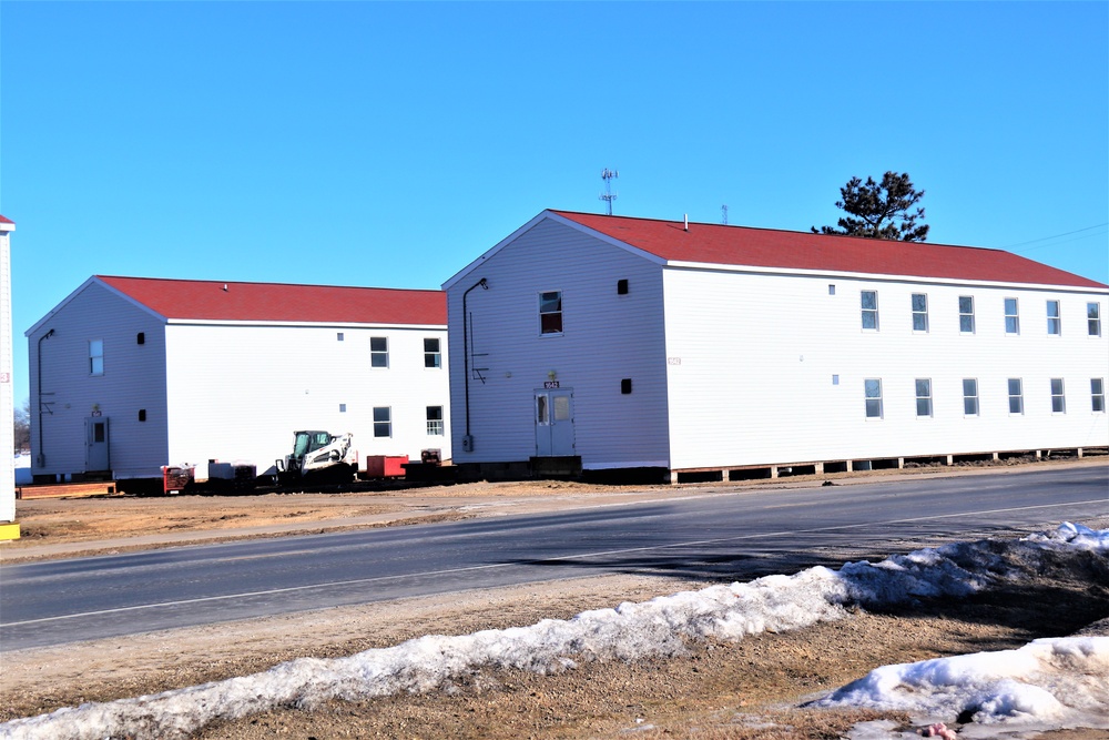 Contractors moving four World War II-era barracks buildings at Fort McCoy