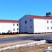 Contractors moving four World War II-era barracks buildings at Fort McCoy