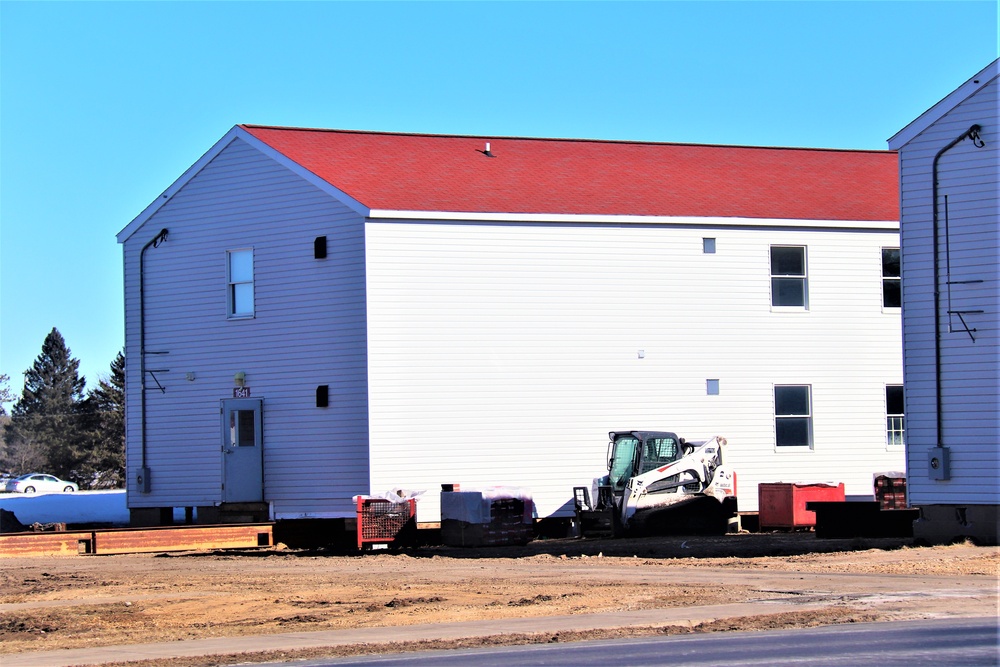 Contractors moving four World War II-era barracks buildings at Fort McCoy