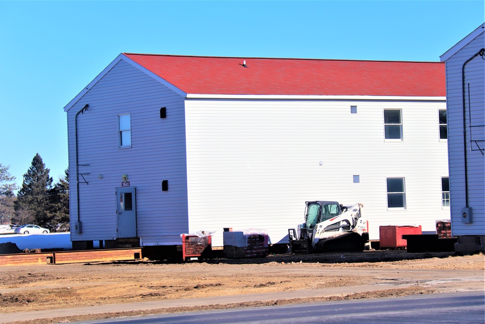 Contractors moving four World War II-era barracks buildings at Fort McCoy