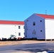 Contractors moving four World War II-era barracks buildings at Fort McCoy