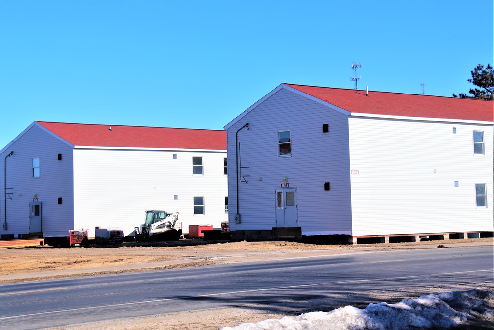 Contractors moving four World War II-era barracks buildings at Fort McCoy