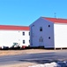 Contractors moving four World War II-era barracks buildings at Fort McCoy