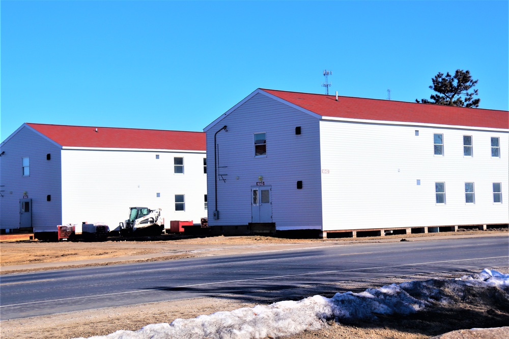 Contractors moving four World War II-era barracks buildings at Fort McCoy