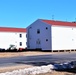 Contractors moving four World War II-era barracks buildings at Fort McCoy