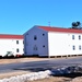 Contractors moving four World War II-era barracks buildings at Fort McCoy