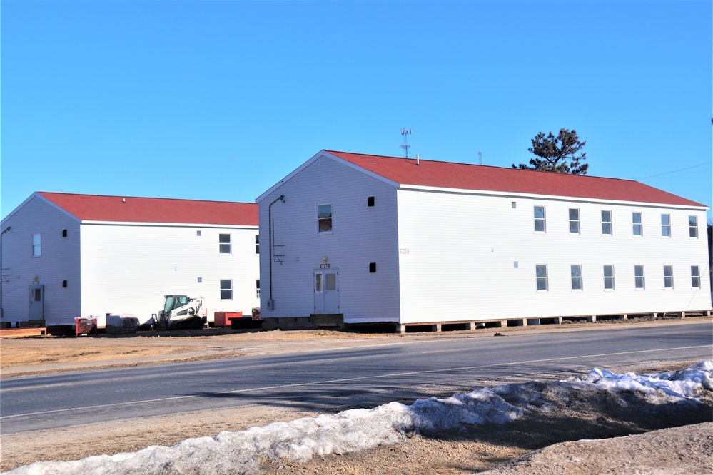 Contractors moving four World War II-era barracks buildings at Fort McCoy