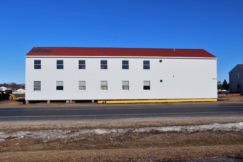 Contractors moving four World War II-era barracks buildings at Fort McCoy