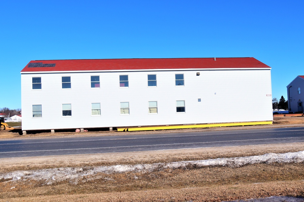 Contractors moving four World War II-era barracks buildings at Fort McCoy