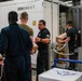 Sailors Move Supplies In a Working Party Aboard USS Oakland