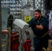 Sailors Move Supplies In a Working Party Aboard USS Oakland