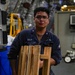 Sailors Move Supplies In a Working Party Aboard USS Oakland