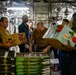 Sailors Move Supplies In a Working Party Aboard USS Oakland