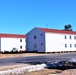 Contractors moving four World War II-era barracks buildings at Fort McCoy