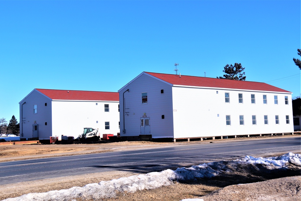 Contractors moving four World War II-era barracks buildings at Fort McCoy