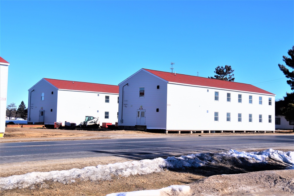 Contractors moving four World War II-era barracks buildings at Fort McCoy