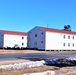 Contractors moving four World War II-era barracks buildings at Fort McCoy