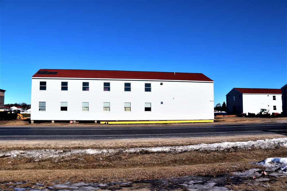 Contractors moving four World War II-era barracks buildings at Fort McCoy