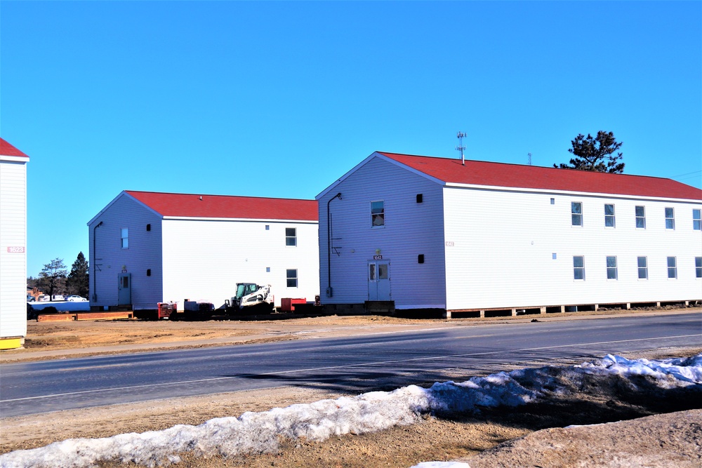 Contractors moving four World War II-era barracks buildings at Fort McCoy