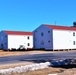 Contractors moving four World War II-era barracks buildings at Fort McCoy