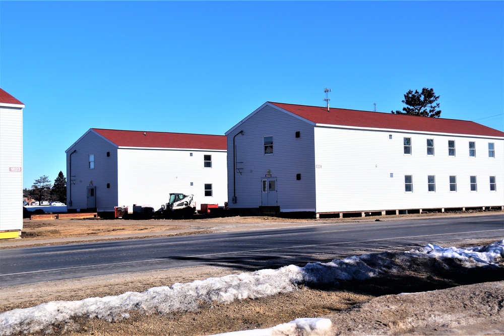 Contractors moving four World War II-era barracks buildings at Fort McCoy