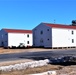 Contractors moving four World War II-era barracks buildings at Fort McCoy