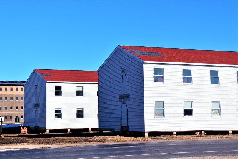 Contractors moving four World War II-era barracks buildings at Fort McCoy