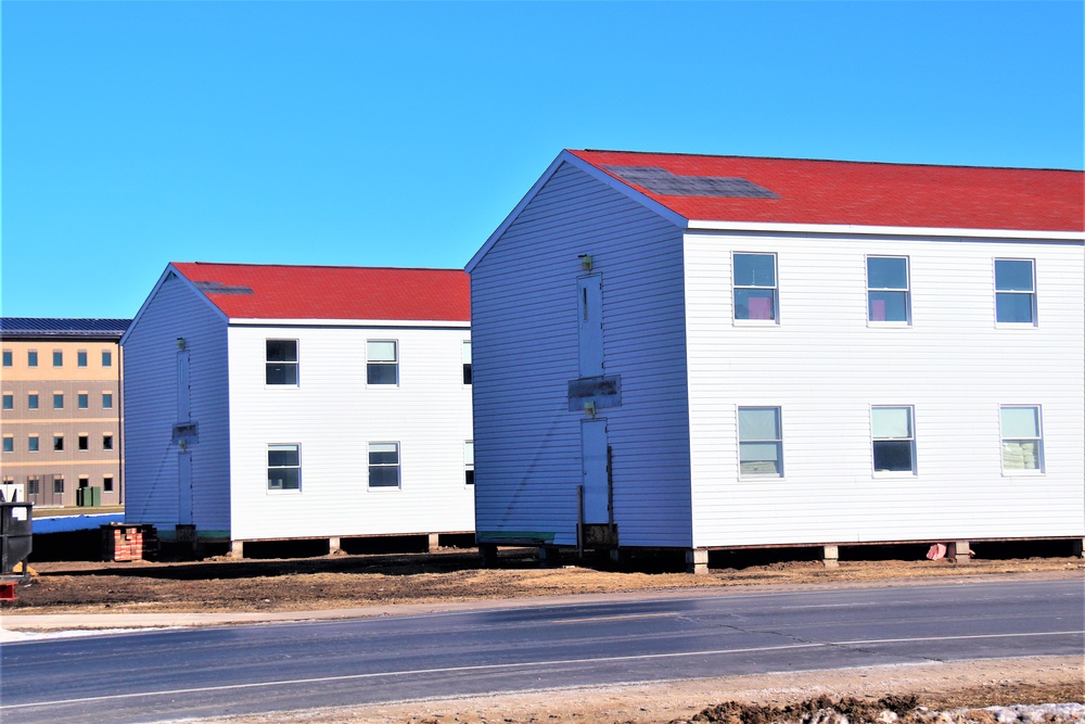 Contractors moving four World War II-era barracks buildings at Fort McCoy